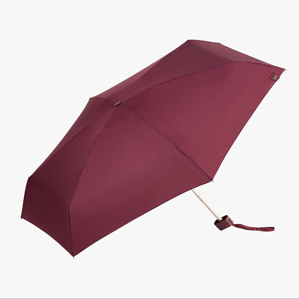 Mini paraguas plegable Clima en color burdeos con funda a juego y diseño compacto.